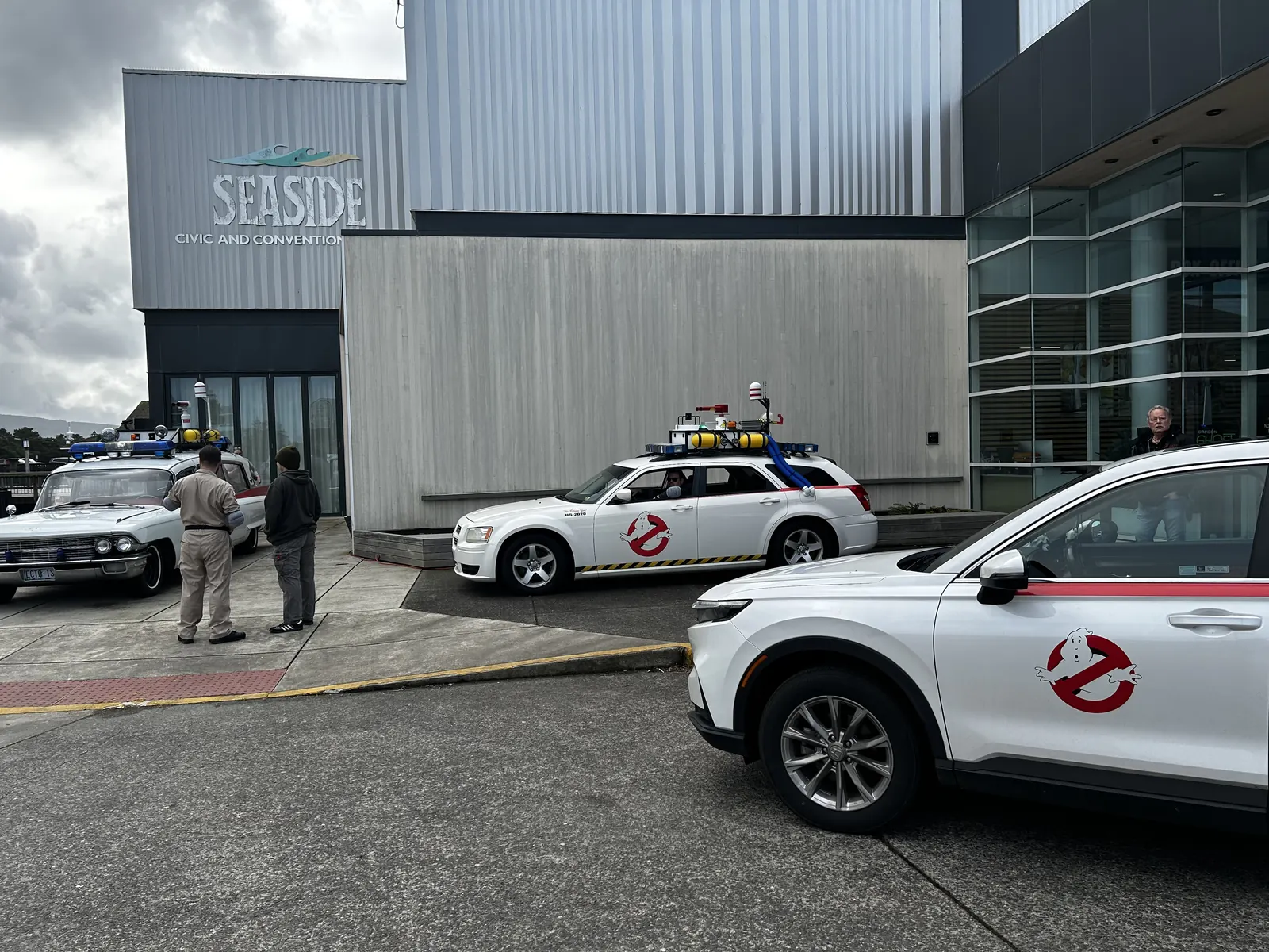 Ecto-style Ghostbusters vehicles lined up outside the Seaside Civic and Convention Center