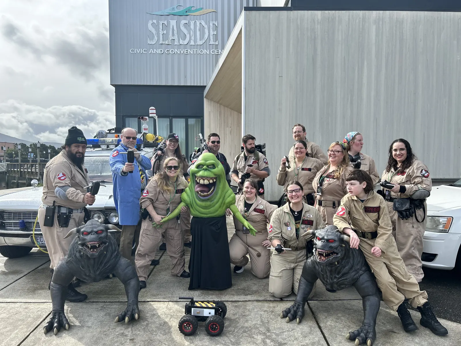 The Ghostbusters cosplay crew posing with Slimer and the terror dogs at the venue entrance