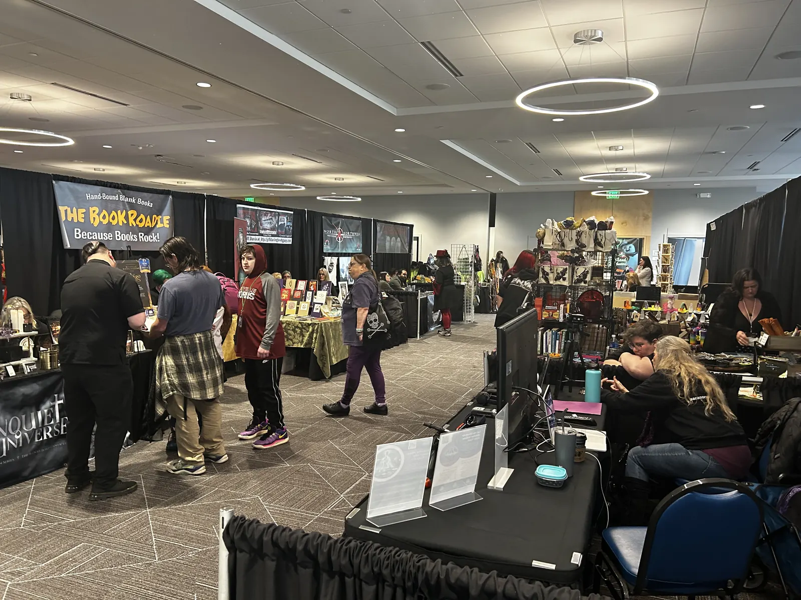 Attendees browsing the used book stall in the vendor hall