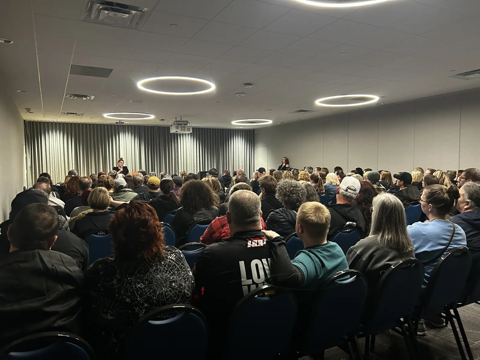 A packed room settling in for an evening event